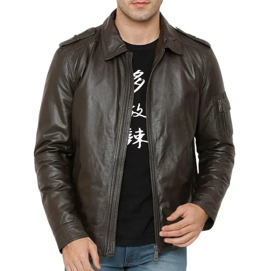 Men's dark brown leather jacket with zip closure and shoulder epaulets, worn over jeans