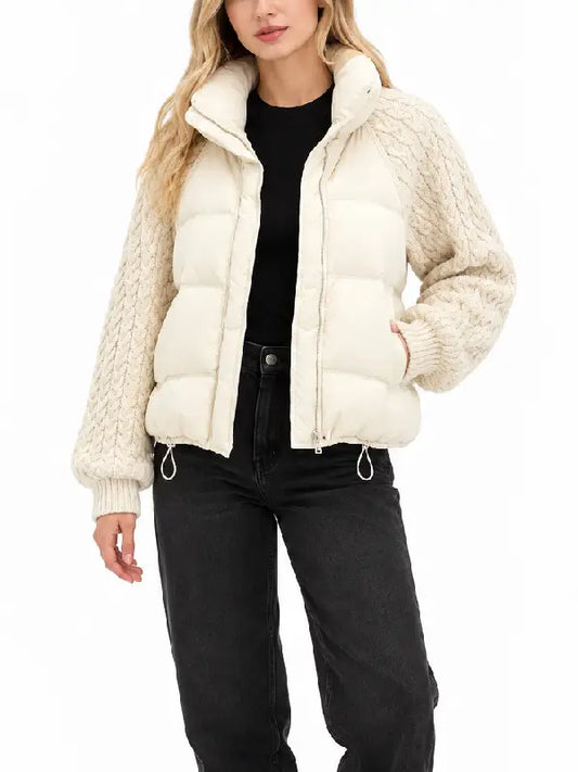 Front view of women's cream cropped puffer jacket with funnel collar, zipper and knit sleeves