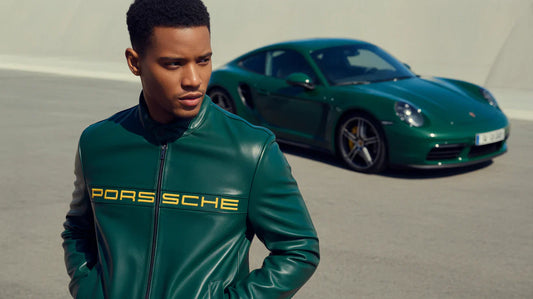 Man in green leather Porsche jacket standing outdoors with matching green sports car