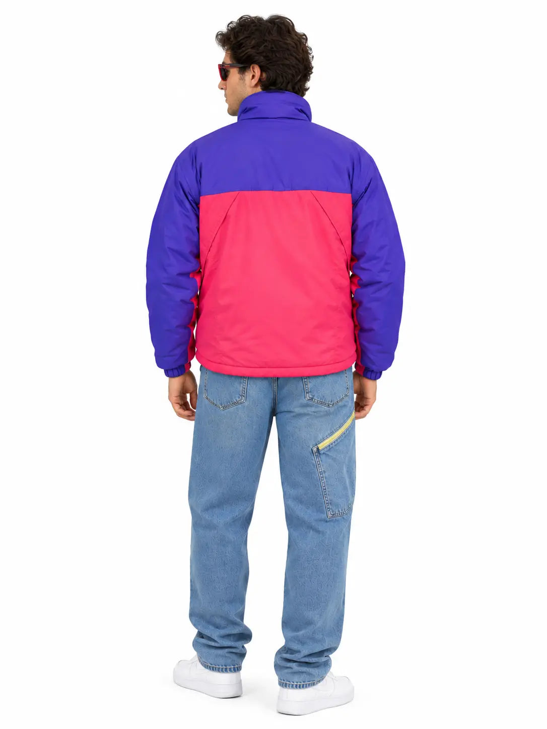 Men's retro purple and pink 90s color-block puffer jacket styled with light-wash jeans on a male model