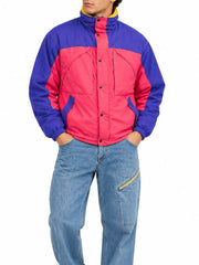 Men's retro purple and pink 90s color-block puffer jacket styled with light-wash jeans on a male model