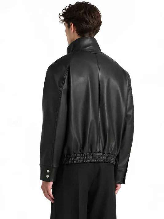 Back view of men's black real leather bomber jacket featuring a raised collar, structured leather panels and gathered waistband.