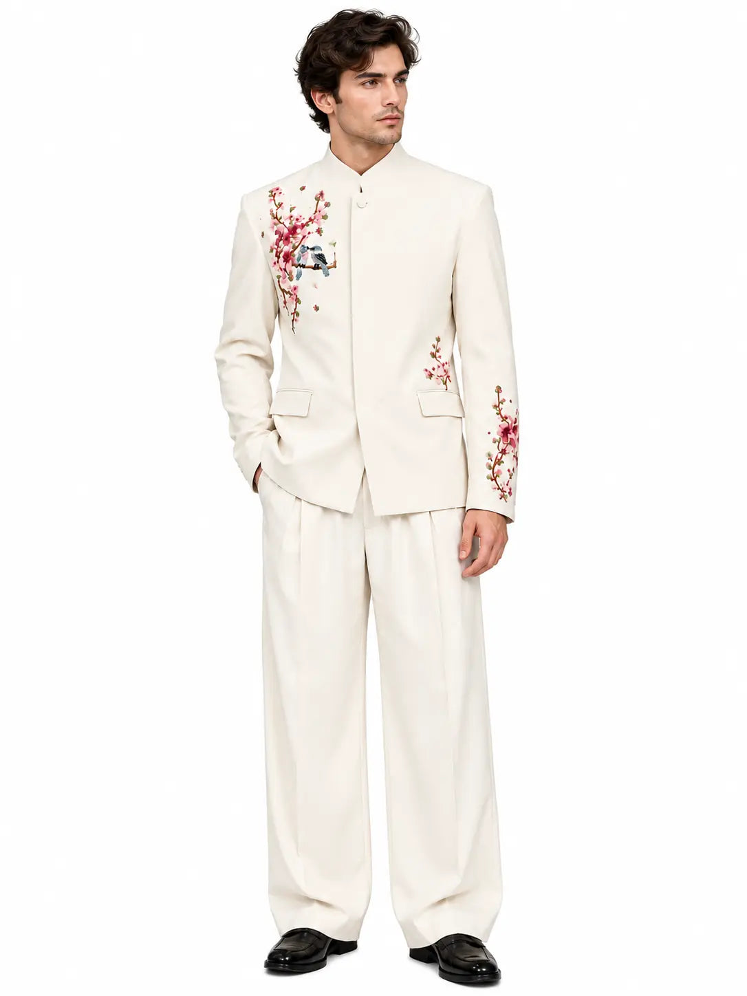 Men's ivory blossom mandarin collar suit with pink floral and bird embroidery, matching wide-leg trousers.
