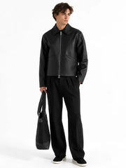 Men's minimalist black real leather jacket featuring a pointed collar, full-length silver zipper and discreet angled welt pockets.