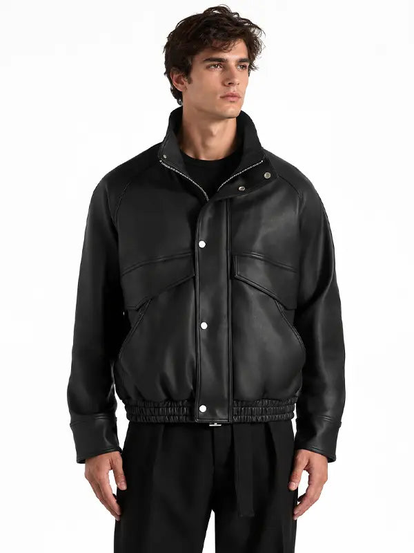 Men's black real leather funnel neck bomber jacket with snap-button front, oversized flap pockets and elasticated waistband.
