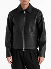 Men's minimalist black real leather jacket featuring a pointed collar, full-length silver zipper and discreet angled welt pockets.