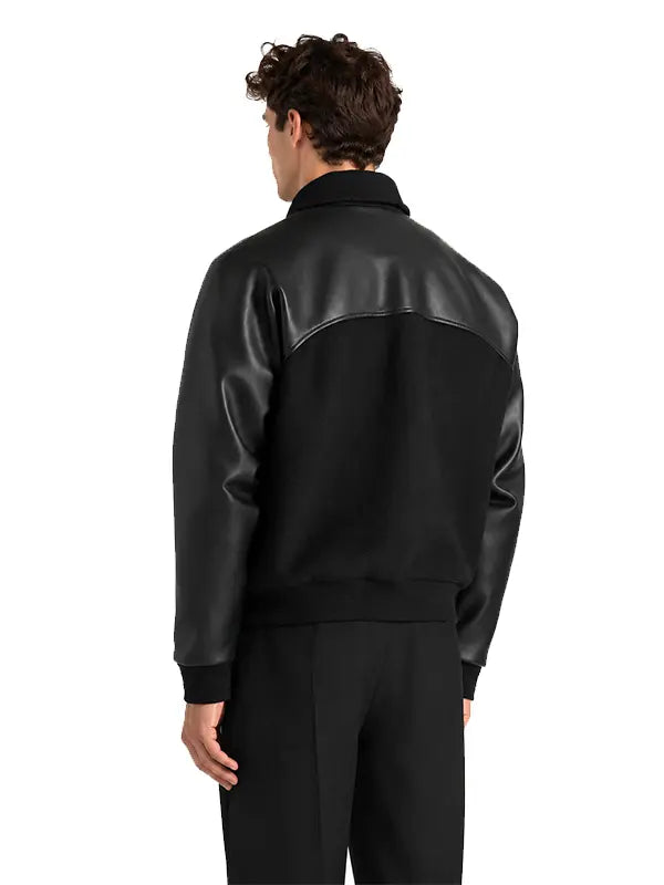 Back view of men's black wool and leather raglan letterman jacket with curved shoulder detailing.