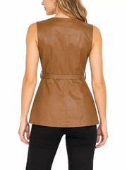Back view of woman wearing a tan leather belted vest with back seams and black pants