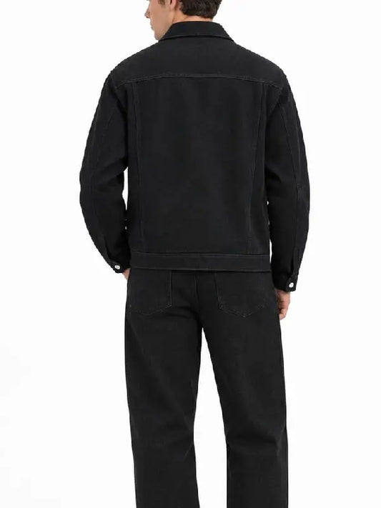 Back view of a men's black denim jacket with yoke seam, shirt-style collar, and button cuffs