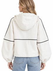 Back view of a women's cream hooded jacket with black contrast piping and balloon sleeves with elastic cuffs