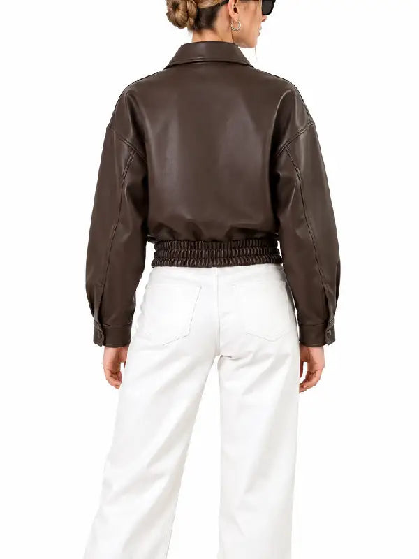 Back view of women's brown cropped leather bomber jacket with elastic hem