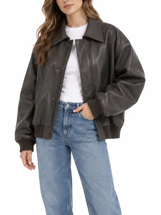 Woman wearing a brown vintage bomber jacket with turn-down collar, concealed zip, and ribbed cuffs