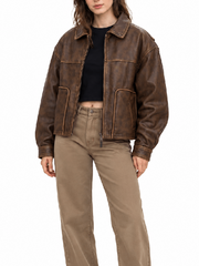 Front view of women’s distressed brown leather jacket with zip front and pockets