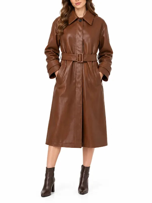 Full-length front view of women’s brown leather belted trench coat styled with brown ankle boots