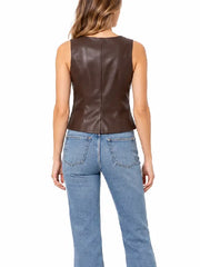 Back view of woman wearing a brown leather vest with center seam and blue straight-leg jeans