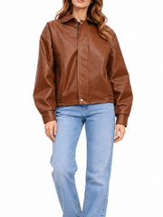 Full front view of women’s oversized brown leather jacket styled with light-wash jeans