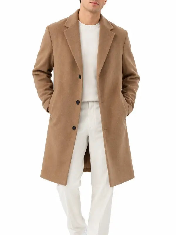 Front view of a man wearing a camel button-front overcoat with notch lapel over a white sweater