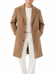 Front view of a man wearing a camel button-front overcoat with notch lapel over a white sweater