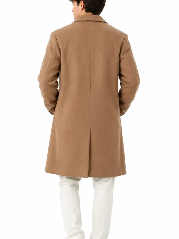 Back view of a man wearing a camel long overcoat with center vent and white trousers
