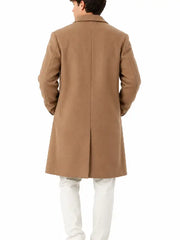 Back view of a man wearing a camel long overcoat with center vent and white trousers