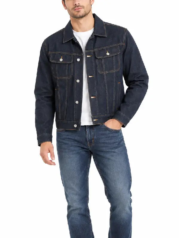 Man wearing dark rinse wash denim trucker jacket with jeans and white sneakers, front view