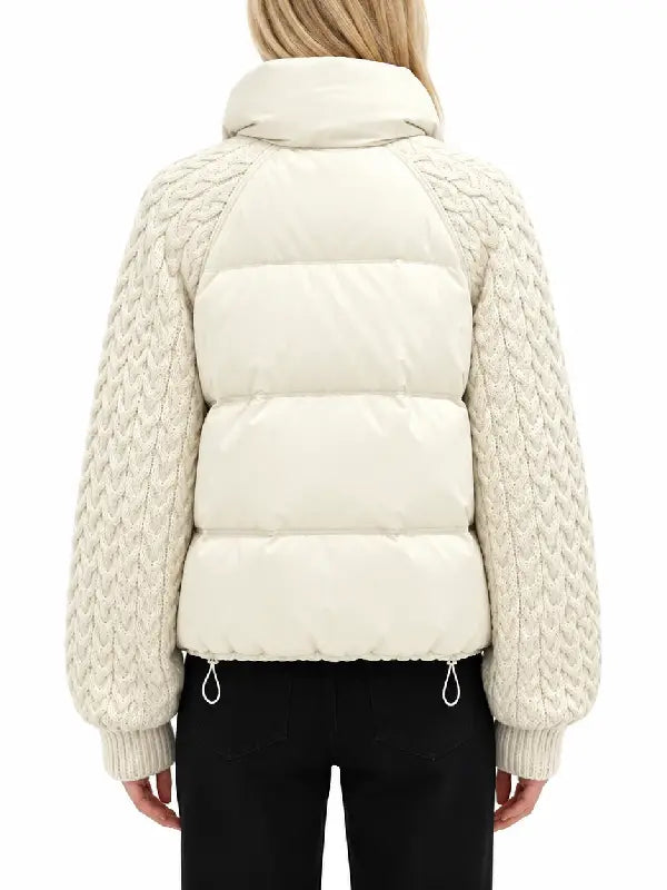 Back view of women's cream puffer jacket with cable-knit raglan sleeves and drawcord hem