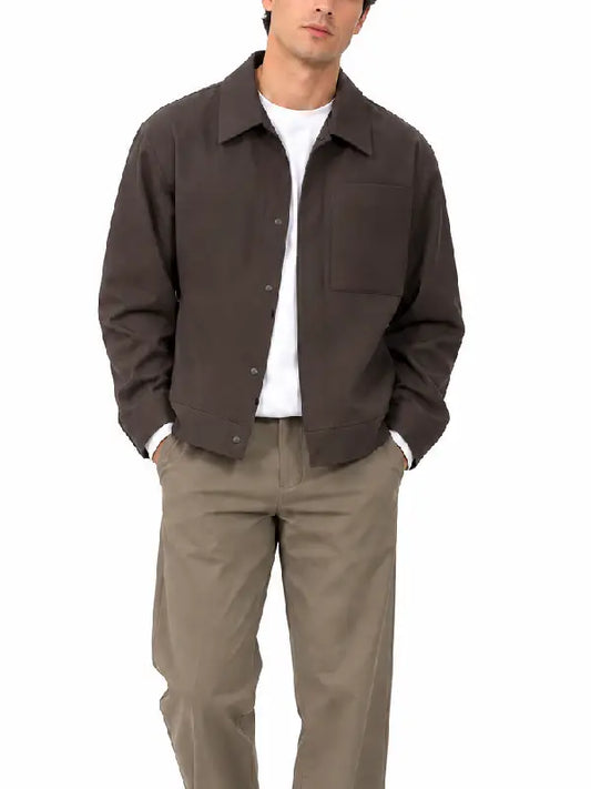 Front view of a man wearing a dark brown snap-button jacket with chest pocket 