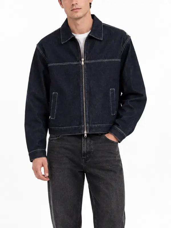 Man wearing a dark indigo denim zip-up jacket with white contrast stitching and shirt-style collar, front view