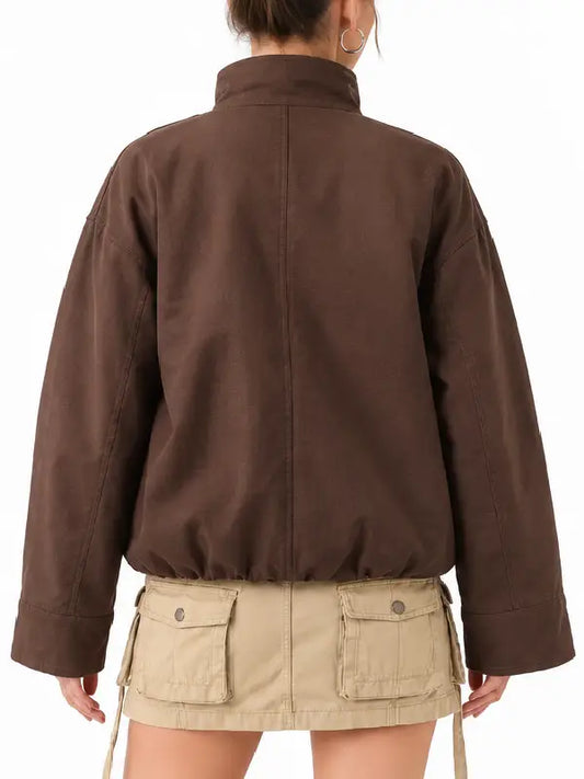 Back view of a women's brown oversized ripstop jacket with drop shoulders, wide cuffs and drawstring hem
