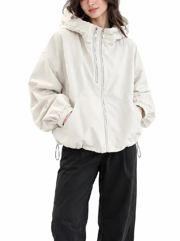 Front view of a women's cream zip-up hooded jacket with side pockets, elastic cuffs, and drawstring hem