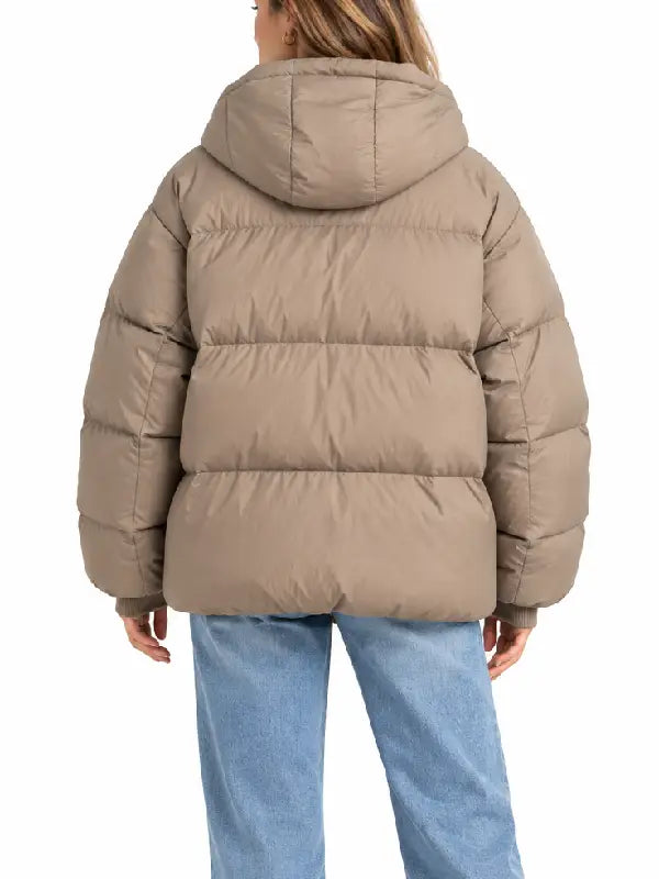 Back view of taupe oversized hooded puffer jacket showing quilted paneling and hood