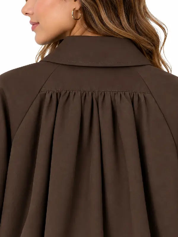 Close-up of brown jacket collar and shoulder pleating detail