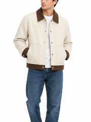 Front view of a men's cream snap button jacket with a brown collar, patch pockets, and contrast hem band