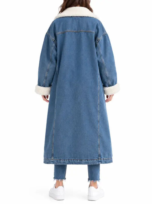 Back view of women’s long blue denim coat with sherpa collar and folded sherpa cuffs