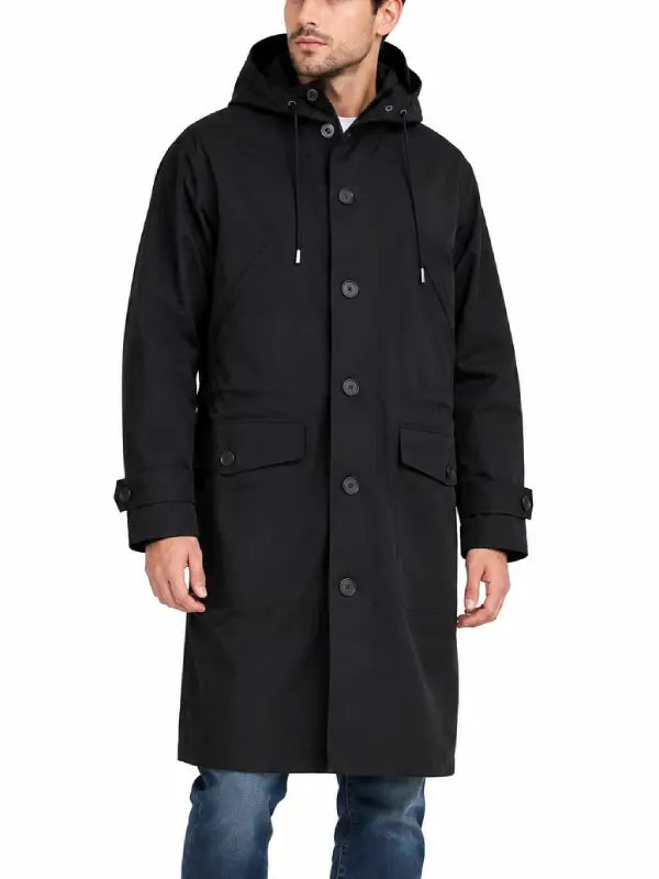 Front view of man wearing black button-front hooded trench coat