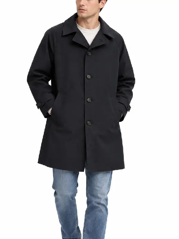 Man wearing a black mid-length car coat with point collar, button front, and side pockets