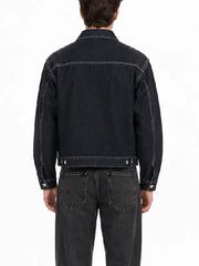Back view of a men's dark denim jacket with contrast stitching, yoke seam, and button waist adjusters