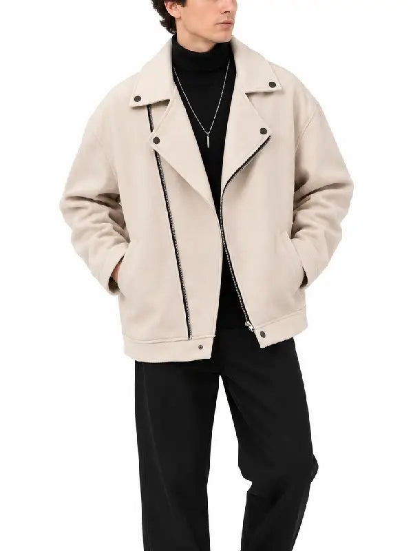 Front view of men's beige asymmetrical zip biker jacket with lapel collar, worn with a black turtleneck