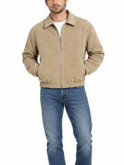 Man wearing khaki suede zip-up jacket with jeans, full front view