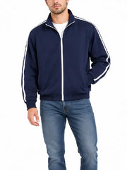 Man wearing navy striped track jacket with jeans, front view