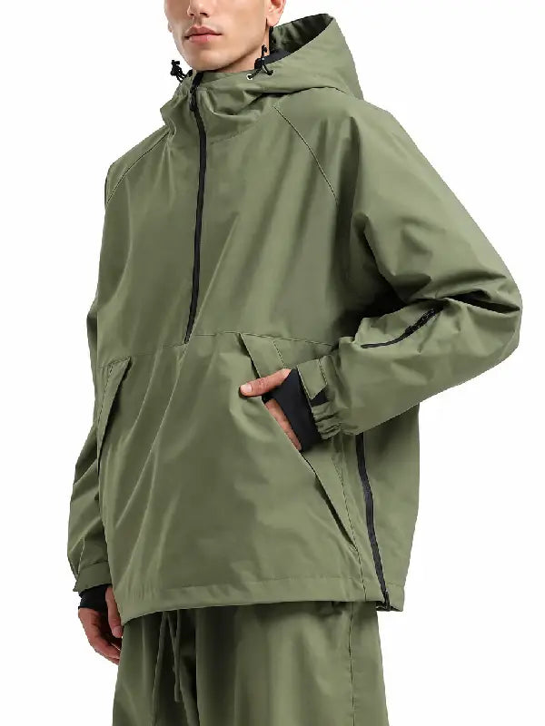 Man wearing an olive green half-zip hooded pullover jacket with angled hand pockets and zippered sleeve pocket