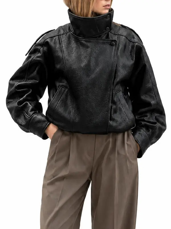 Front close-up of black real leather oversized biker jacket with high stand collar and asymmetric snap front