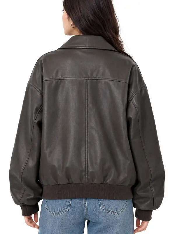 Back view of women's brown oversized faux leather bomber jacket with yoke seam and ribbed hem