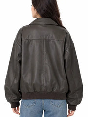 Back view of women's brown oversized faux leather bomber jacket with yoke seam and ribbed hem