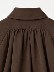 Close-up of brown jacket collar and shoulder pleating detail
