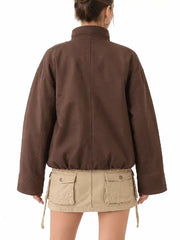 Back view of a women's brown oversized ripstop jacket with drop shoulders, wide cuffs and drawstring hem