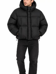 Front view of cropped black hooded puffer jacket with zipped closure and drawstring hem