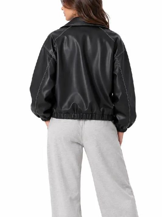 Back view of a women’s black oversized leather bomber jacket with white contrast stitching and elastic hem
