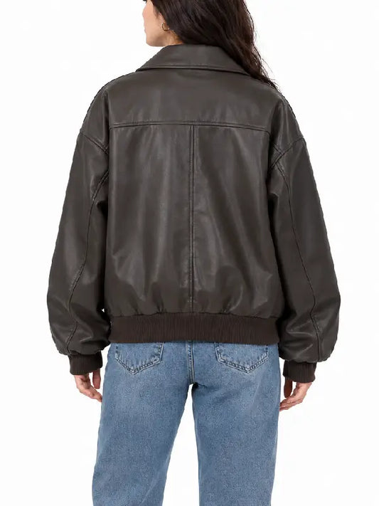 Back view of women's brown oversized faux leather bomber jacket with yoke seam and ribbed hem