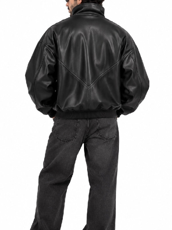Back view of a men’s oversized black leather bomber jacket with V-shaped seam detail and ribbed hem